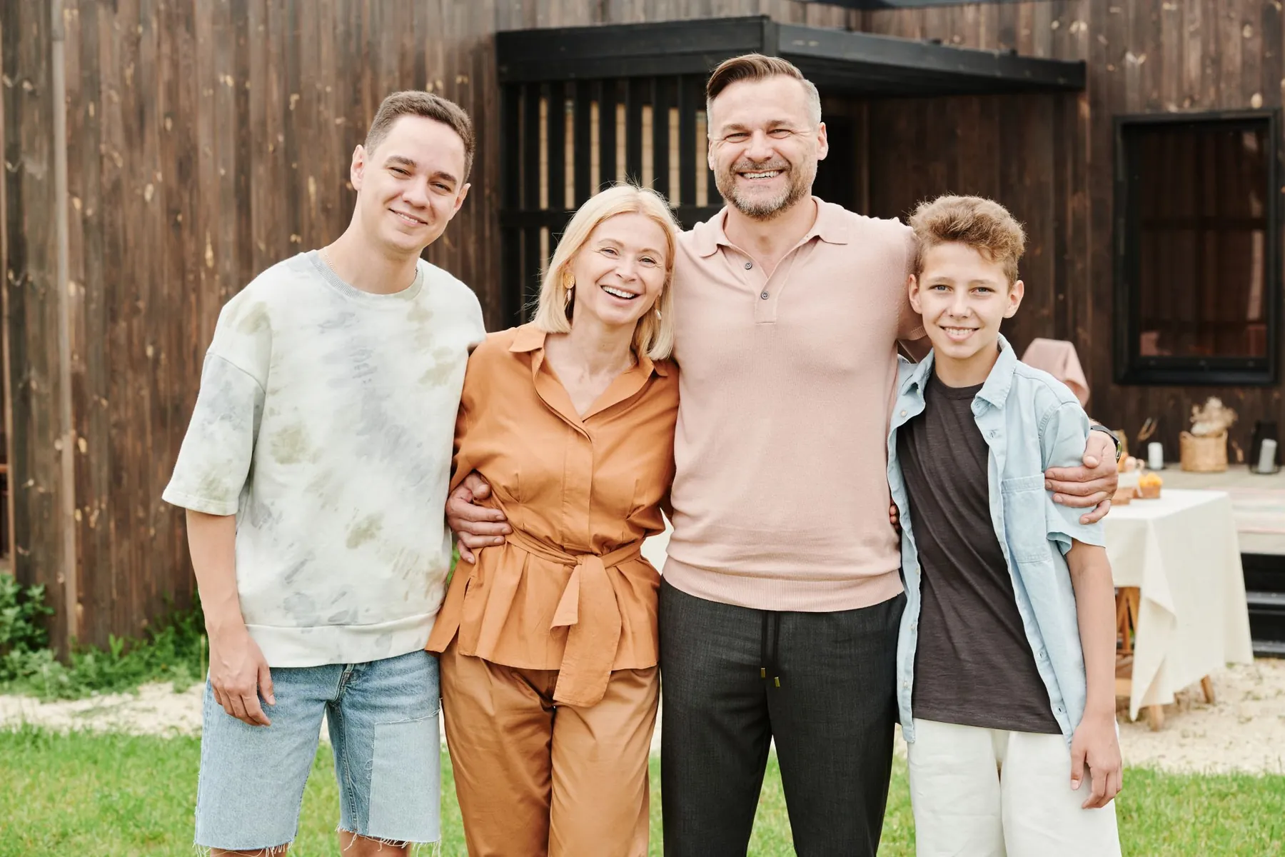 Parents and their two sons smiling outdoors