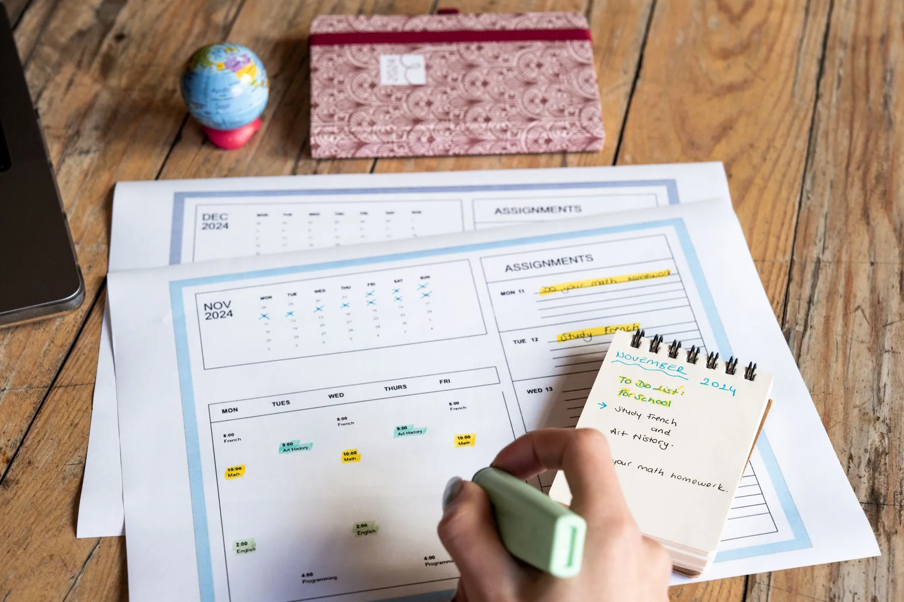 A monthly planner and notes on a desk