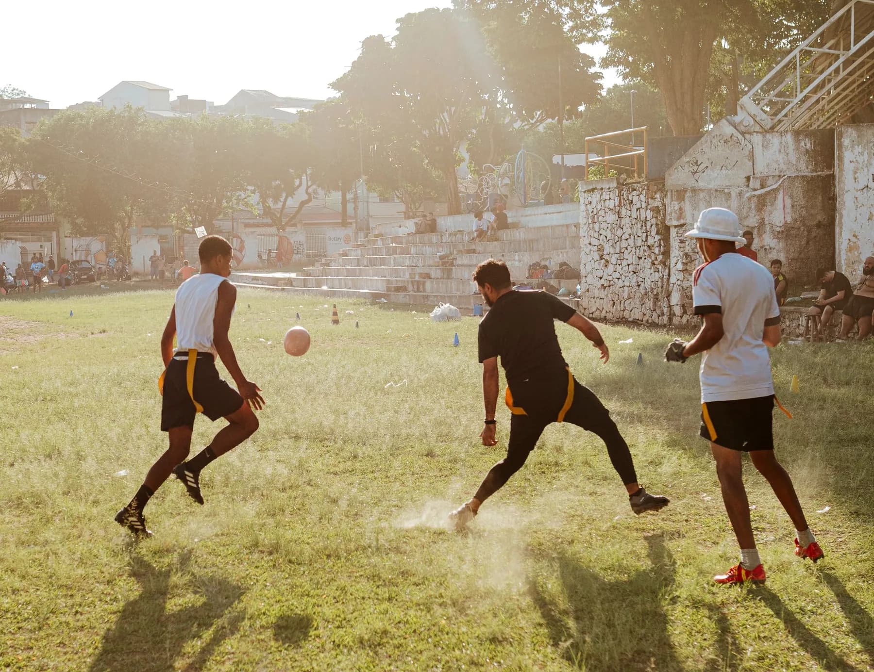 Young men playing football in the evening sun