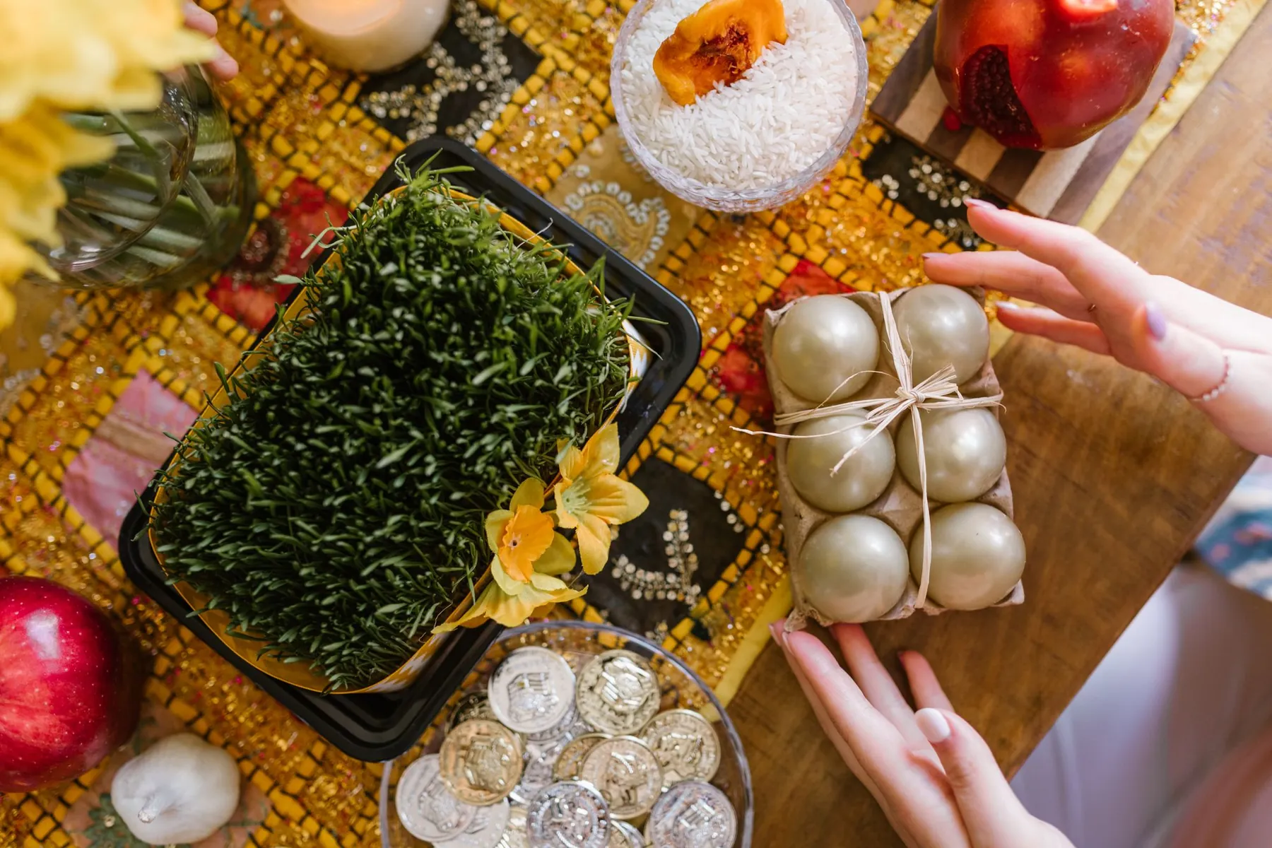 A Navruz table with sprouted wheat, pomegranates and sweets