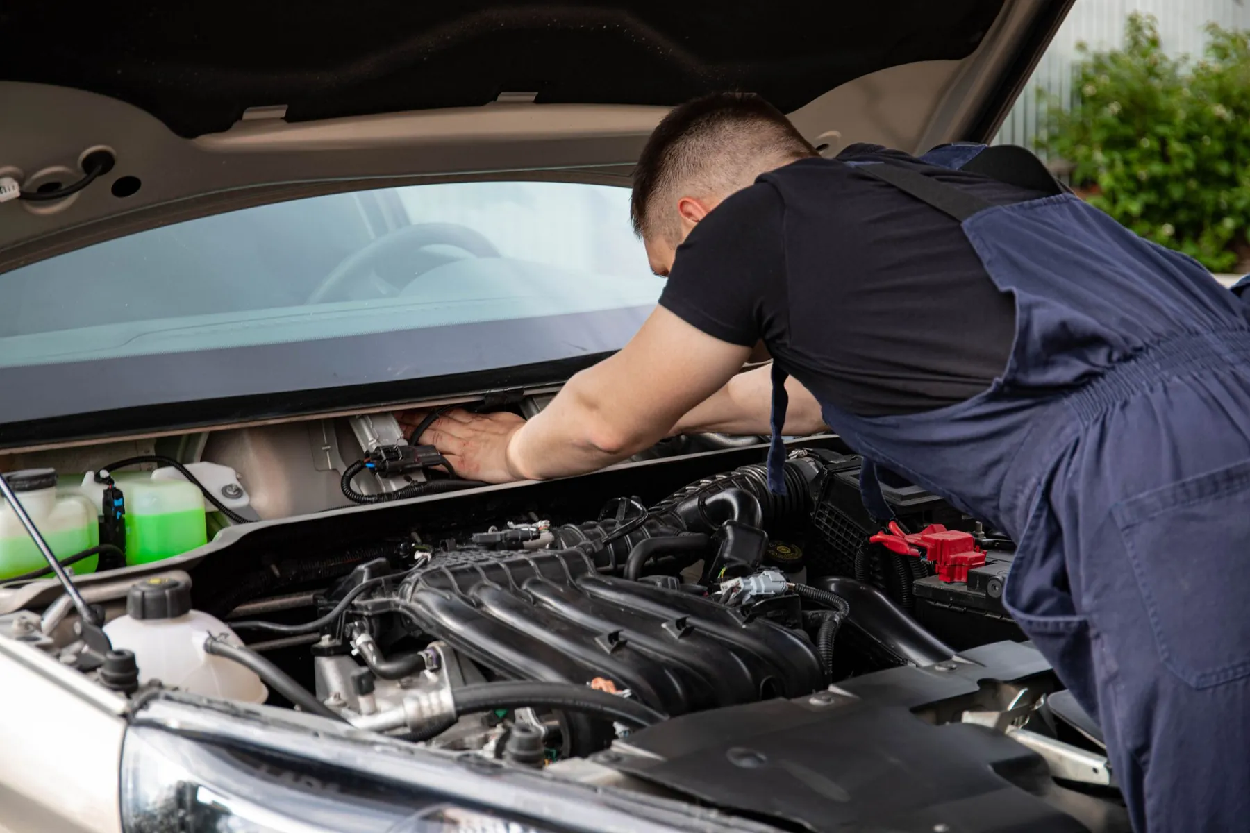 A mechanic working on a car engine