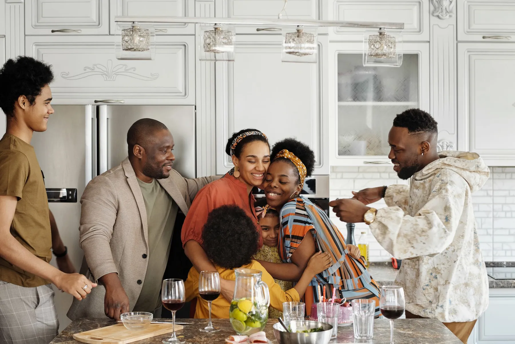 A family hugging and celebrating in the kitchen