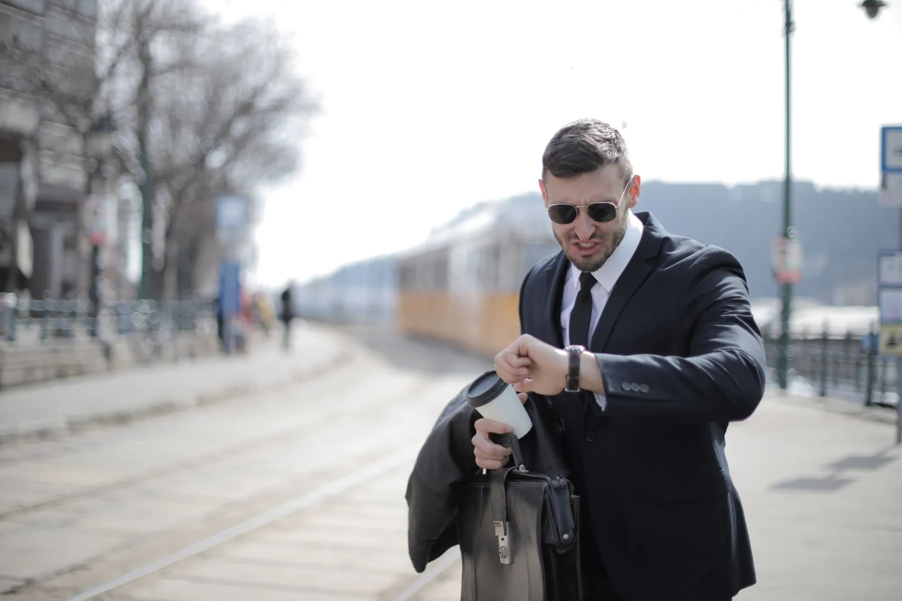 A man in a hurry checking his watch
