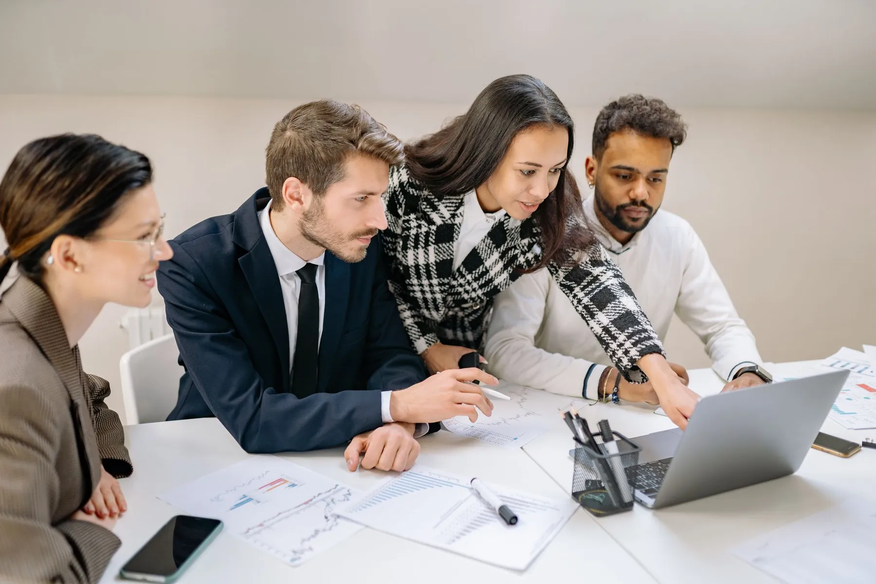 A team working together around a laptop