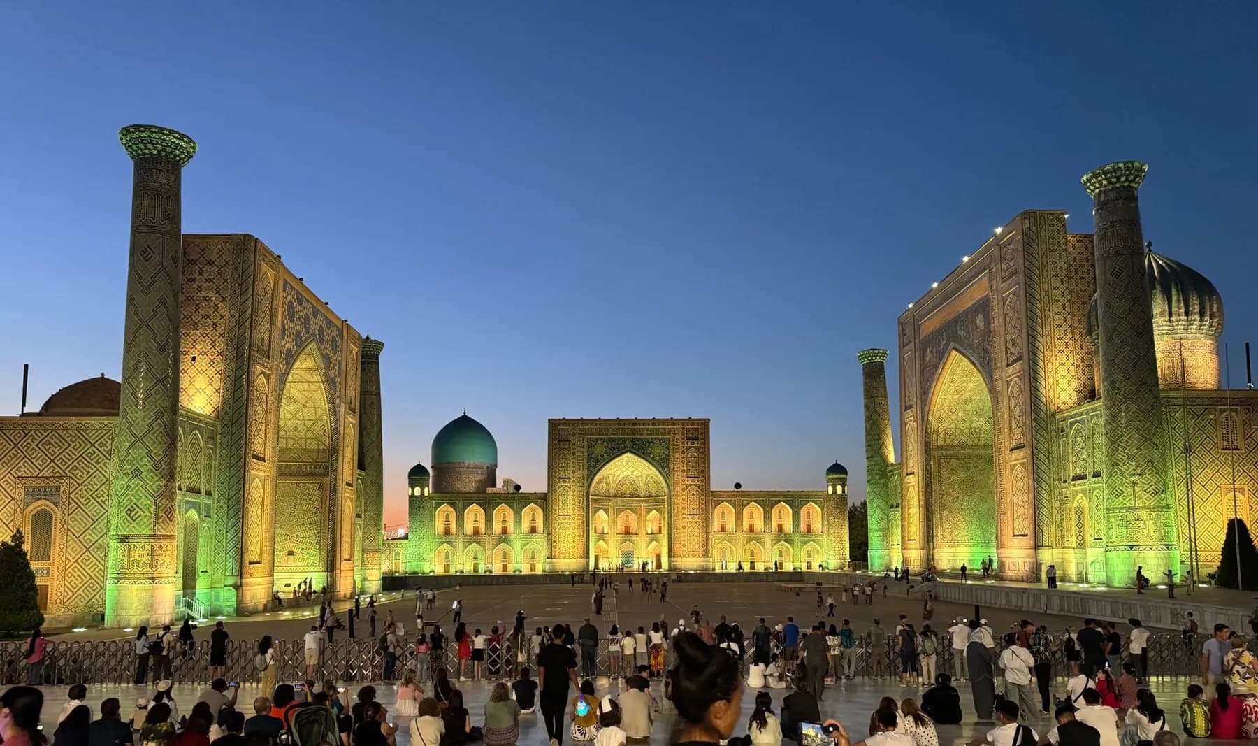 Registan Square in Samarkand in the evening, full of visitors